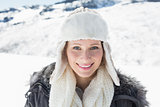 Woman in warm clothing on snow covered landscape
