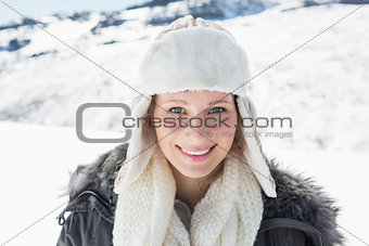 Woman in warm clothing on snow covered landscape