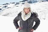 Woman in warm clothing on snowed landscape