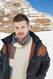 Man in warm clothing standing on snow covered landscape
