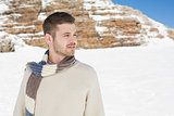 Man in warm clothing looking away on snowed landscape