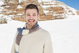 Portrait of cheerful man on snow covered landscape