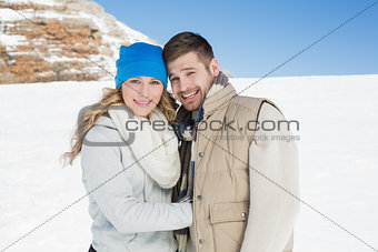 Couple in warm clothing on snow covered landscape