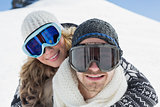 Close up of a couple in ski goggles against snow