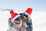 Close up of a cheerful couple in ski goggles on snow