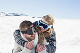 Cheerful couple in ski goggles on snow