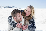 Close up of a cheerful couple holding hands on snow