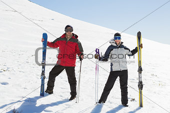 Full length of a couple with ski boards on snow