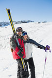 Cheerful couple with ski boards on snow
