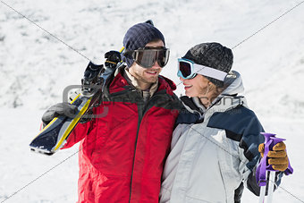 Happy young couple with ski boards on snow