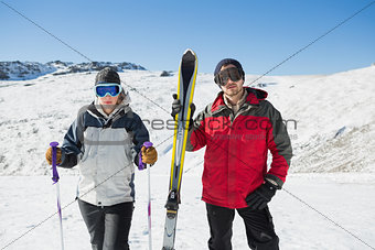 Portrait of a serious couple with ski equipment on snow