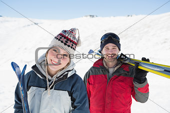 Portrait of a smiling couple with ski boards nn snow
