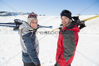 Rear view portrait of a couple with ski boards on snow