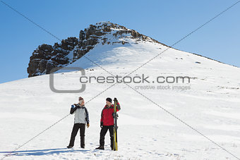 Full length of a couple with ski boards on snow