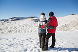 Full length rear view of a couple standing on snow