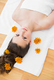 Brunette lying on massage table in beauty salon