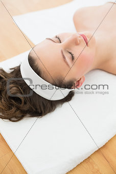 Brunette lying with eyes closed in beauty salon