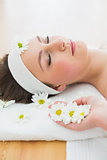 Beautiful woman lying on massage table in beauty salon