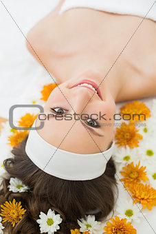 Beautiful woman with flowers in beauty salon