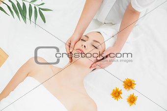 Hands massaging a beautiful woman's face