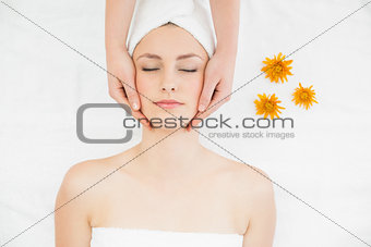 Hands massaging a beautiful woman's face