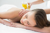 Beautiful woman enjoying oil massage at beauty spa