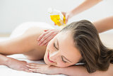 Close up of beautiful woman enjoying oil massage