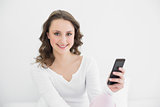 Smiling young woman with mobile phone
