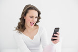 Young woman shouting into mobile phone