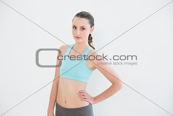 Portrait of a toned woman against wall
