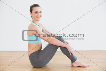 Full length of fit woman in fitness studio