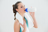 Portrait of fit woman drinking water at the gym