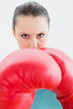 Close up of beautiful woman in red boxing gloves