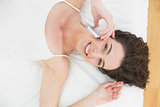 Portrait of a relaxed woman using mobile phone in bed