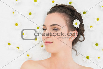 Beautiful woman with flowers in beauty salon