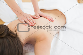 Woman enjoying back massage at beauty spa