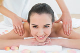 Beautiful woman enjoying shoulder massage at beauty spa