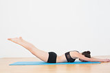 Sporty woman doing the Locust Posture