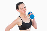 Portrait of a smiling young woman with dumbbell