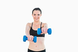 Portrait of a smiling young woman with dumbbells
