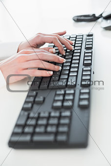 Close up of hands using computer keyboard