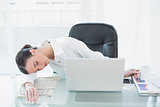 Tired young businesswoman resting in office