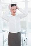 Businesswoman suffering from headache in office