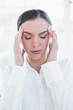 Close up of businesswoman suffering from headache