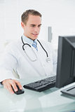 Male doctor using computer at medical office