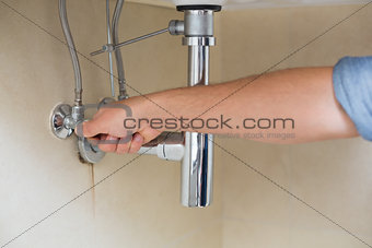 Close up of a plumber repairing washbasin