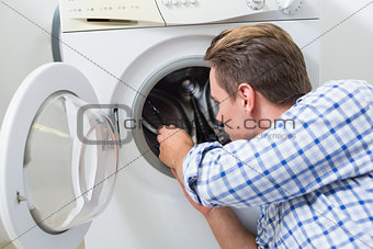 Technician repairing a washing machine