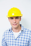 Portrait of a smiling handyman wearing a yellow hard hat