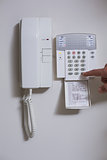 Close up of wall phone and list of numbers