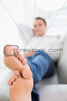Full length of a young man sleeping on sofa